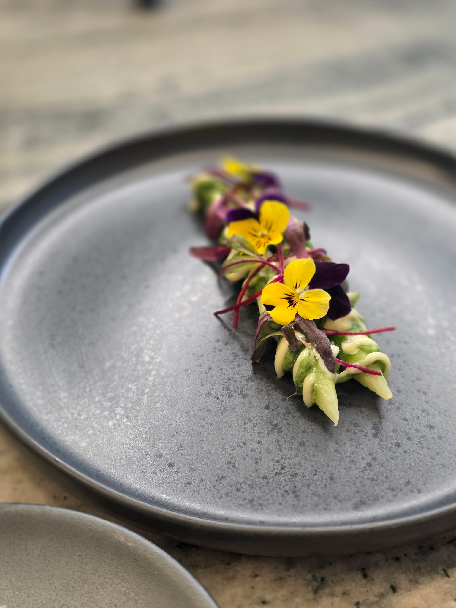 Coiled greens with edible flowers